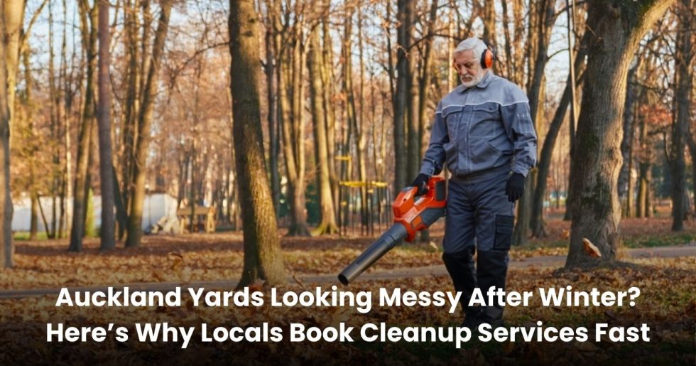 Auckland yard cleanup worker using a leaf blower to clear fallen leaves after winter in a residential area.