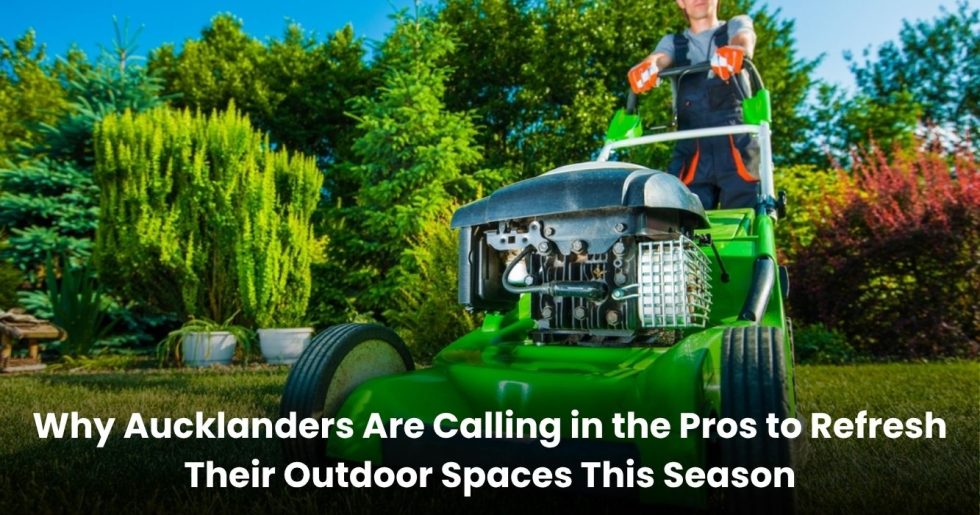 Close-up of a landscaper using a push mower on a vibrant Auckland lawn during a professional landscaping service.