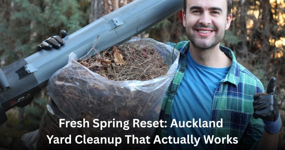 "Man cleaning up yard debris and garden waste during spring cleanup in Auckland, smiling while holding a leaf blower and collection bag.